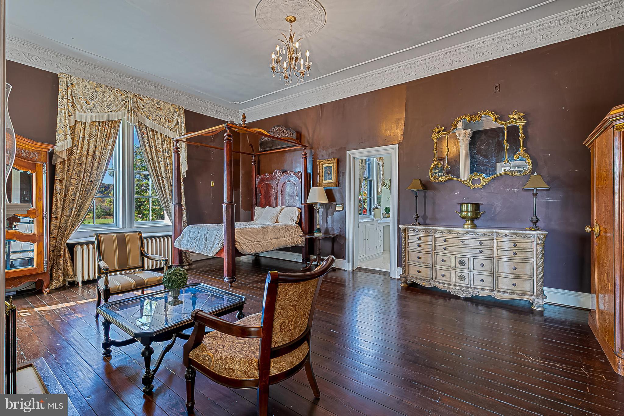 1610 Delaplane Grade Road Upperville, VA 20184 - Photo 92 of 123 a dining room with wooden floor a chandelier a glass table and chairs