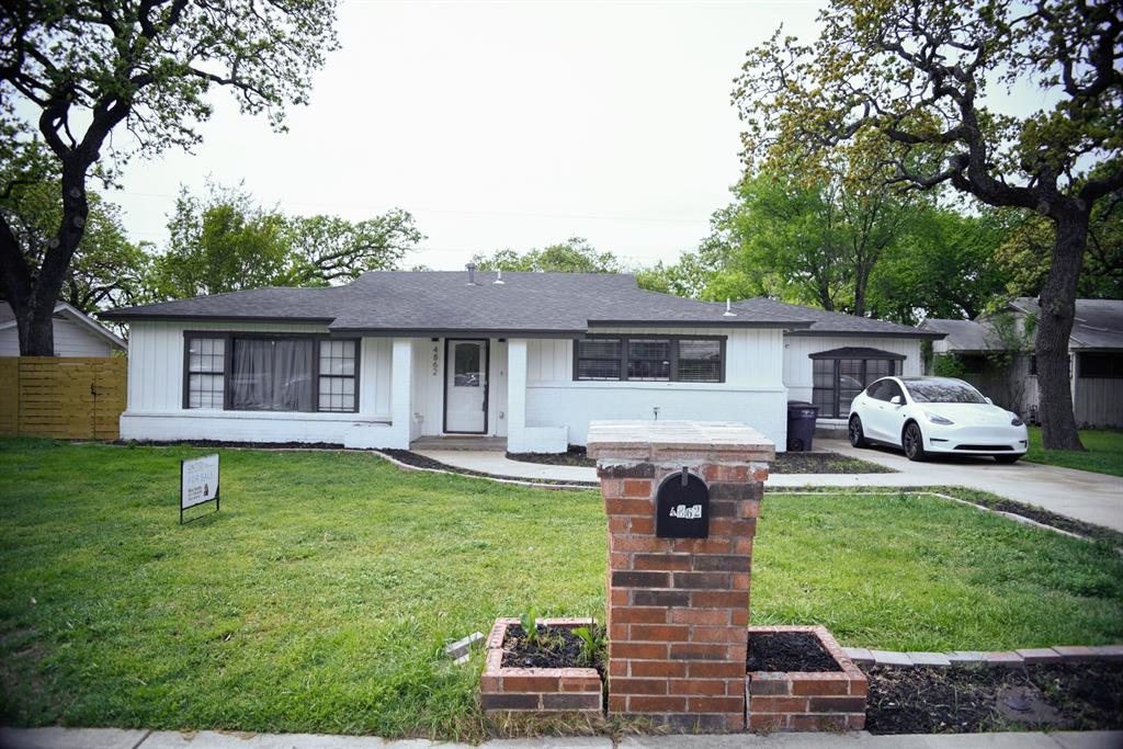 4862 Dunlap Drive Fort Worth, TX 76119 - Photo 1 of 1 a front view of house with a garden and trees
