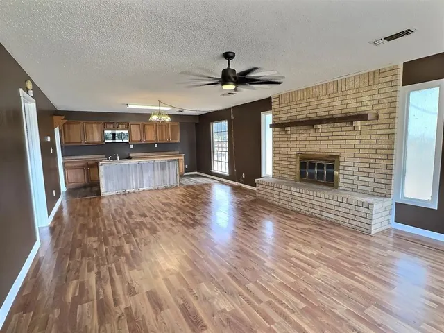 a view of a kitchen with cabinets and wooden floor