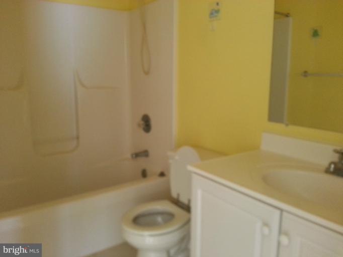 6174 Silver Arrows Way Columbia, MD 21045 - Photo 11 of 25 a white toilet sitting next to a bath tub