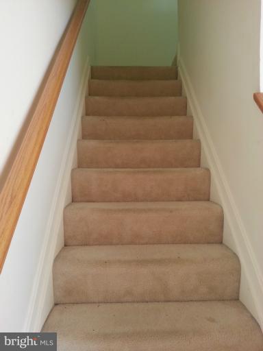 6174 Silver Arrows Way Columbia, MD 21045 - Photo 13 of 25 a view of staircase with white walls