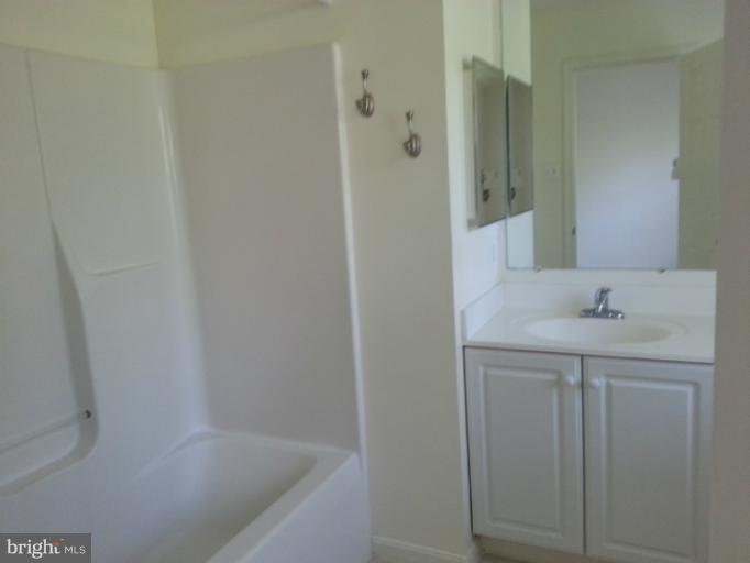 6174 Silver Arrows Way Columbia, MD 21045 - Photo 20 of 25 a bathroom with a shower and a sink