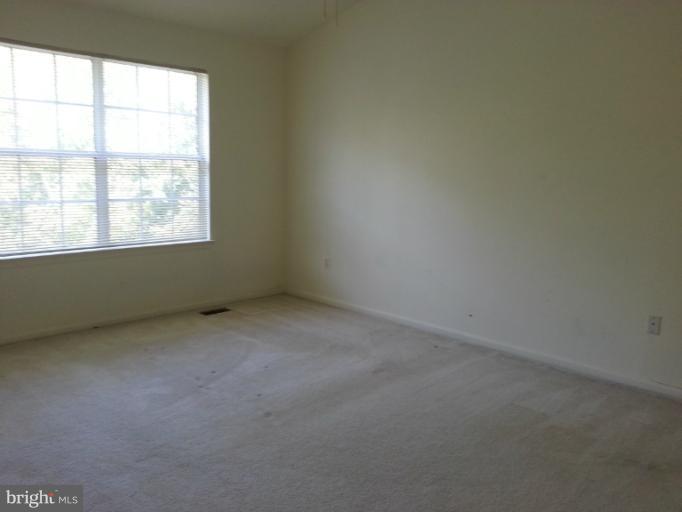 6174 Silver Arrows Way Columbia, MD 21045 - Photo 3 of 25 an empty room with a window