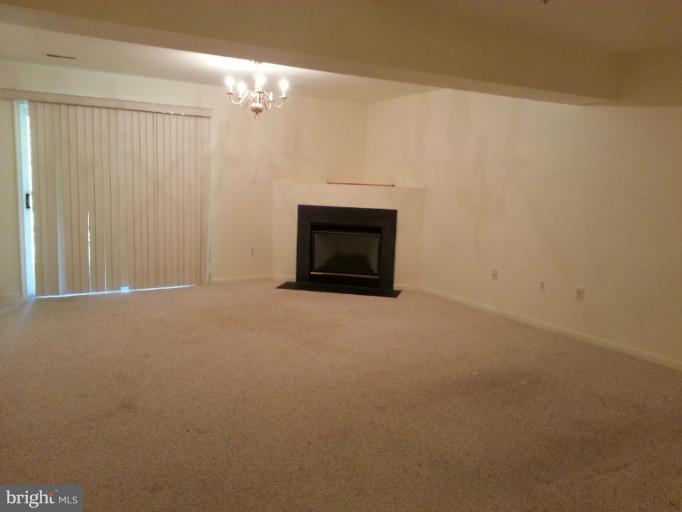 6174 Silver Arrows Way Columbia, MD 21045 - Photo 8 of 25 a view of an empty room with a fireplace