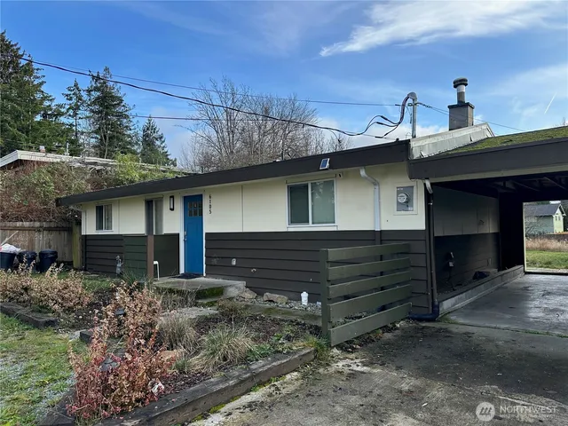 a front view of a house with a garden