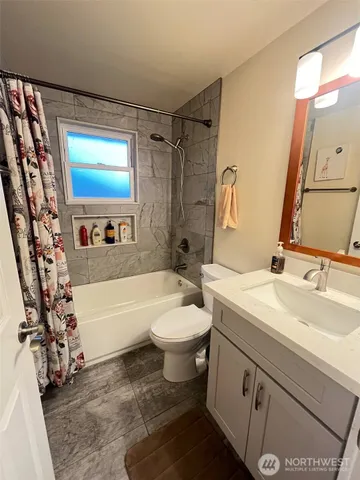 a bathroom with a sink a toilet and bathtub
