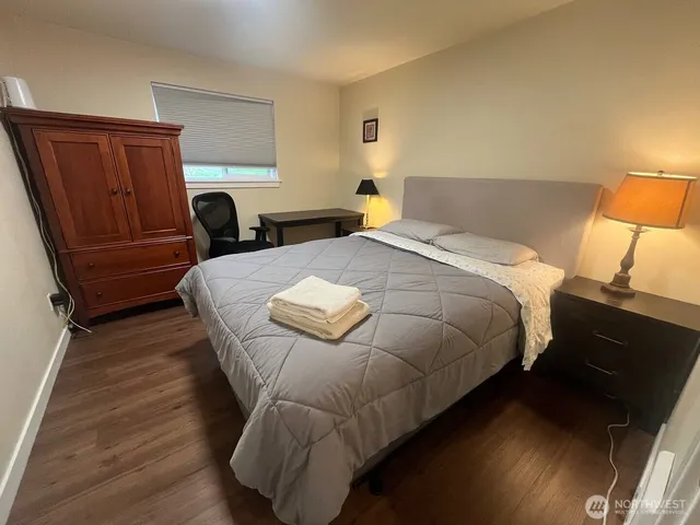 a bedroom with bed and window