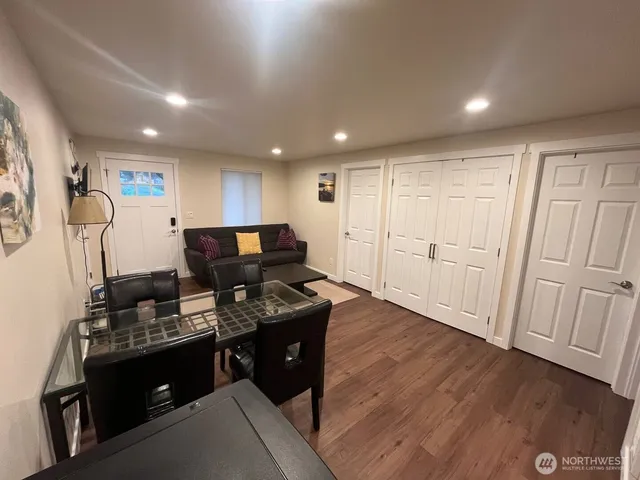 a view of kitchen with stainless steel appliances granite countertop cabinets and wooden floor