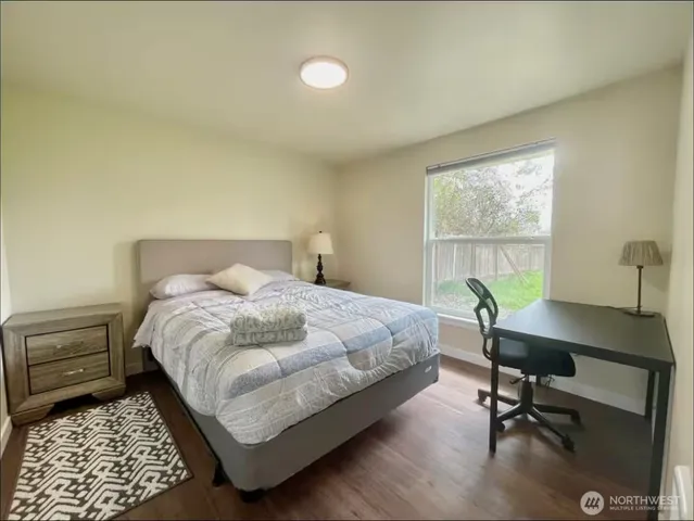 a bedroom with a bed and a desk