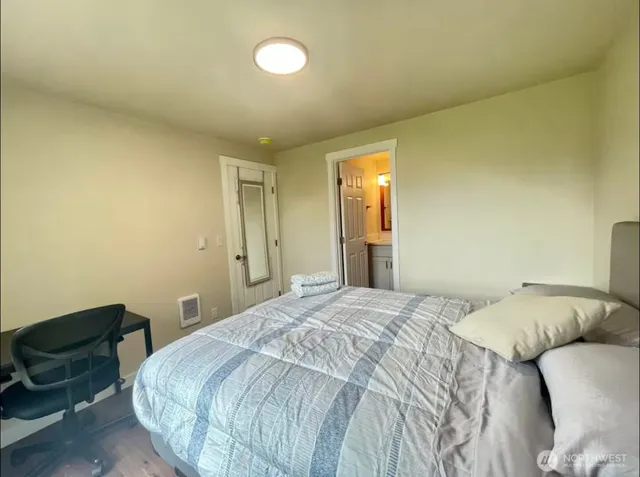 a bedroom with a bed and chair