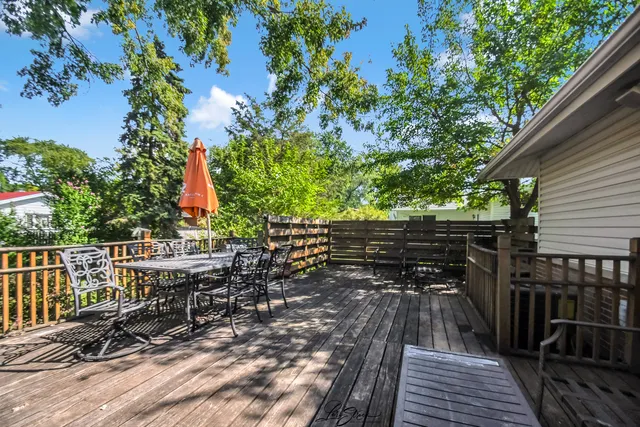 a view of balcony with chairs and wooden fence