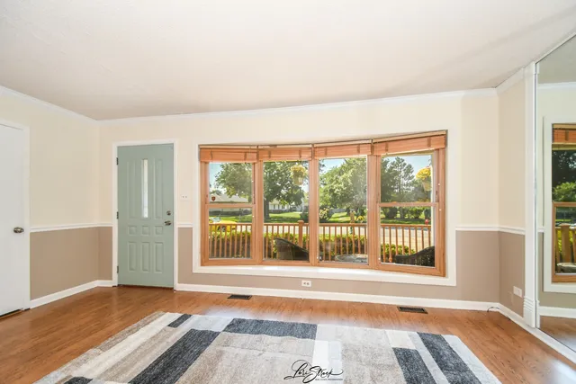 a view of a room with wooden floor and a window