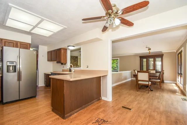 a living room with stainless steel appliances kitchen island granite countertop furniture and a kitchen view