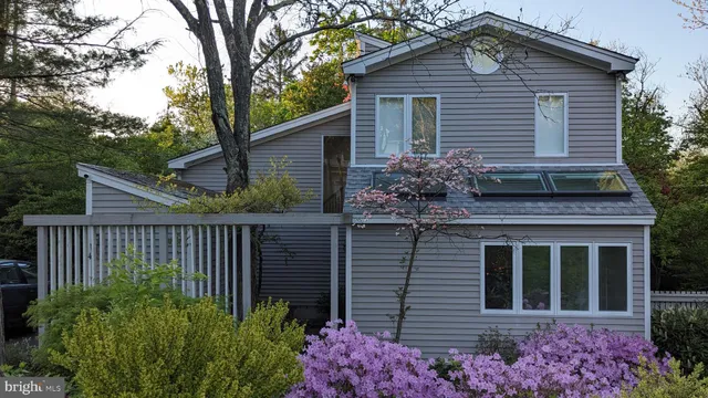 a house that has a tree in front of the house