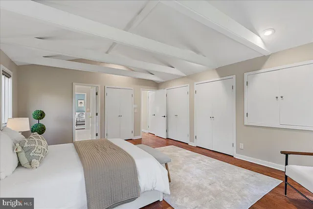 a bedroom with a bed and cabinets