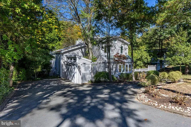 a front view of a house with a tree