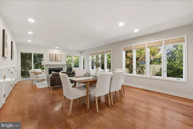 a dining room with furniture window and wooden floor