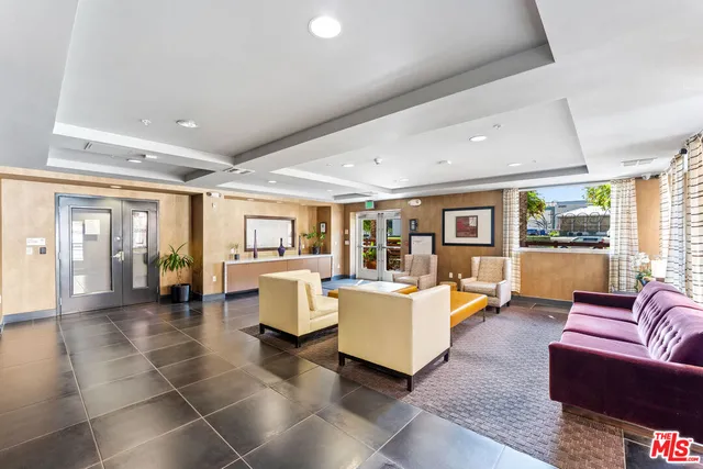 a living room with fireplace furniture and floor to ceiling window