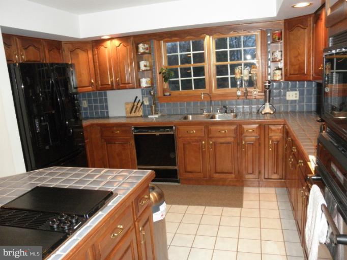 3995 Perry Hall Road Perry Hall, MD 21128 - Photo 18 of 26 a kitchen with a stove a sink and a refrigerator