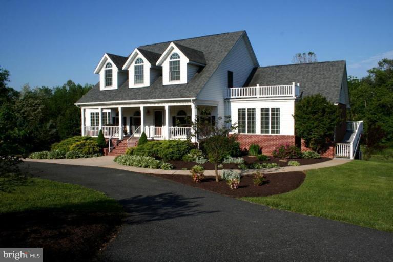 3995 Perry Hall Road Perry Hall, MD 21128 - Photo 22 of 26 a front view of a house with a garden and plants