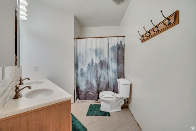 3054 West Ridgeline Road Stockton, UT 84071 - Photo 55 of 88 Bathroom featuring double vanity, light tile patterned floors, and a shower with shower curtain