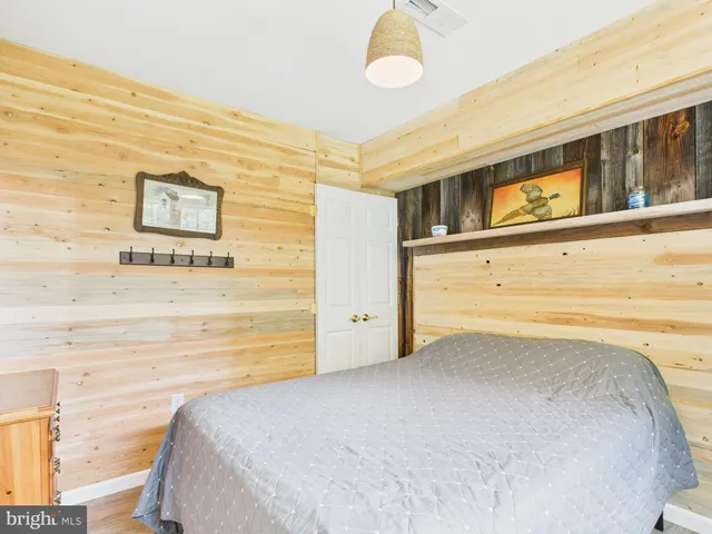 a kitchen with a refrigerator a stove a sink dishwasher and a dining table with wooden floor