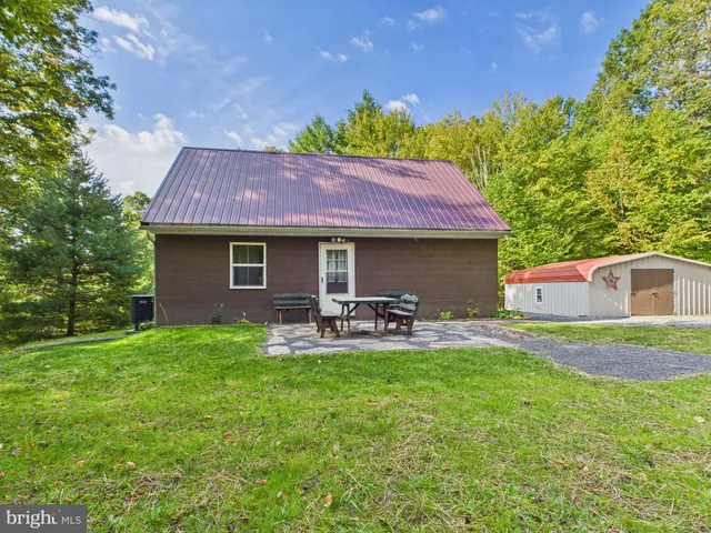 a front view of a house with patio and garden