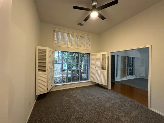 a view of a balcony next to a yard