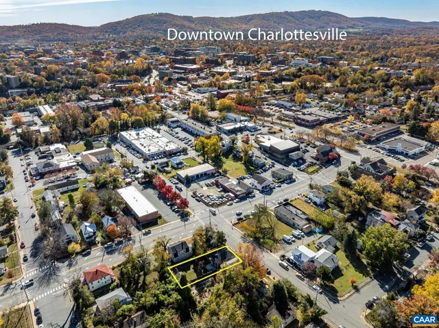 an aerial view of residential houses with city view