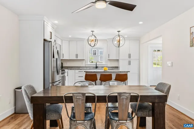 a kitchen with cabinets appliances and a clock