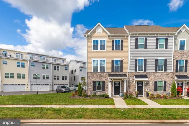 a front view of a residential apartment building with a yard