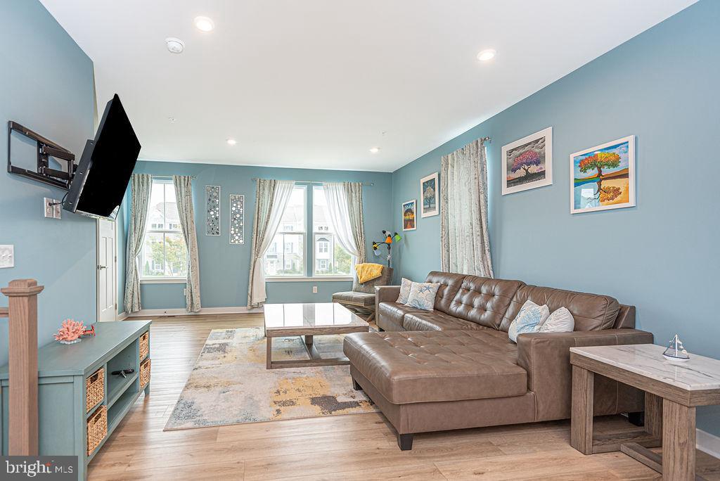 12461 Coastal Marsh Drive, Unit 708 Berlin, MD 21811 - Photo 12 of 56 a living room with furniture and a flat screen tv