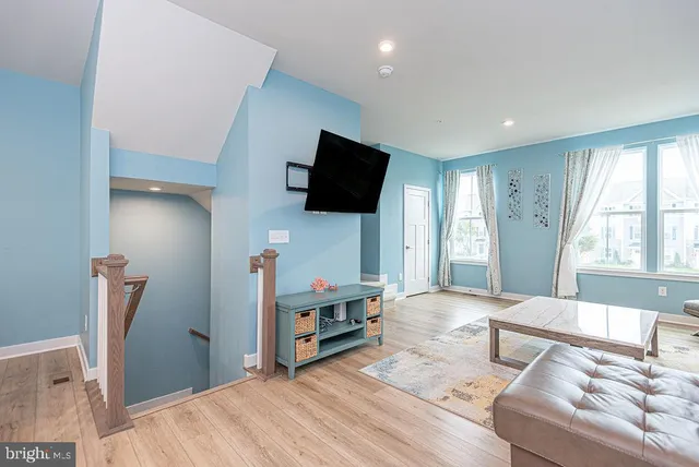 a bedroom with furniture and a flat screen tv