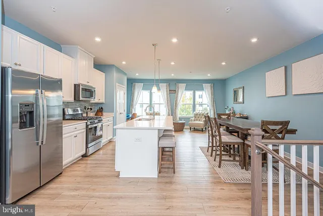 a large kitchen with a table and chairs