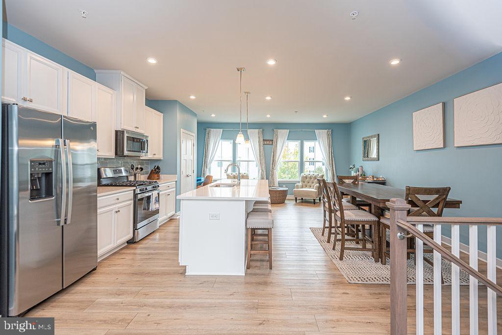 12461 Coastal Marsh Drive, Unit 708 Berlin, MD 21811 - Photo 15 of 56 a large kitchen with a table and chairs