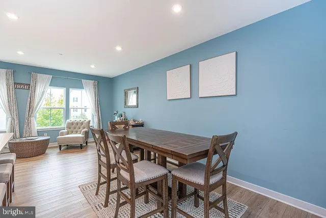 a dining room with furniture and wooden floor