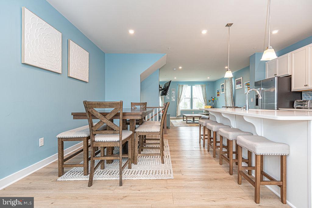12461 Coastal Marsh Drive, Unit 708 Berlin, MD 21811 - Photo 25 of 56 a large kitchen with a table and chairs