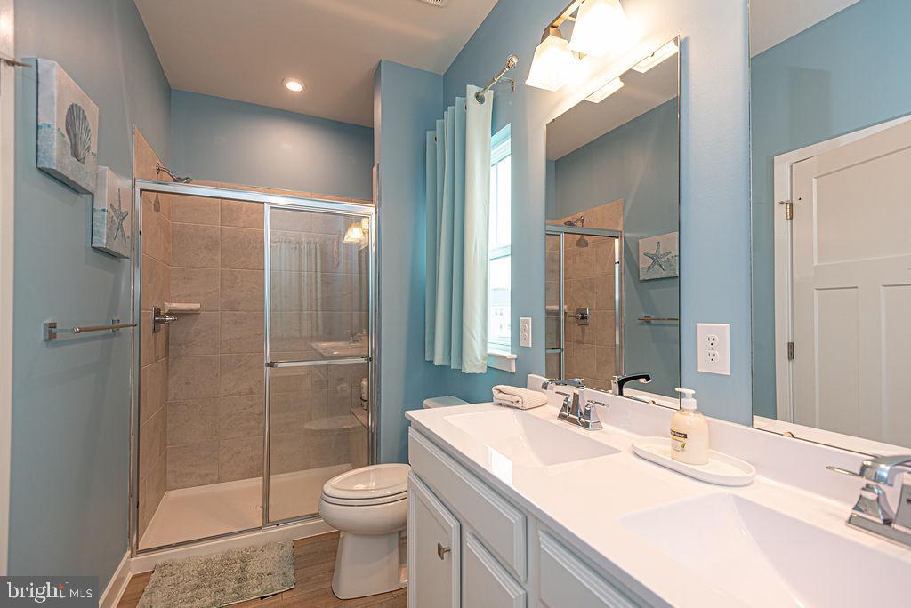 12461 Coastal Marsh Drive, Unit 708 Berlin, MD 21811 - Photo 31 of 56 a bathroom with a sink toilet and shower