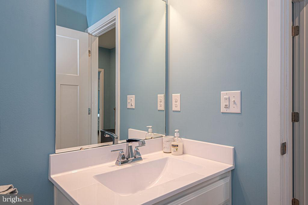 12461 Coastal Marsh Drive, Unit 708 Berlin, MD 21811 - Photo 34 of 56 a bathroom with a sink and a mirror