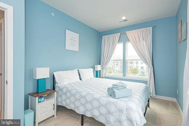 a bedroom with a bed and window