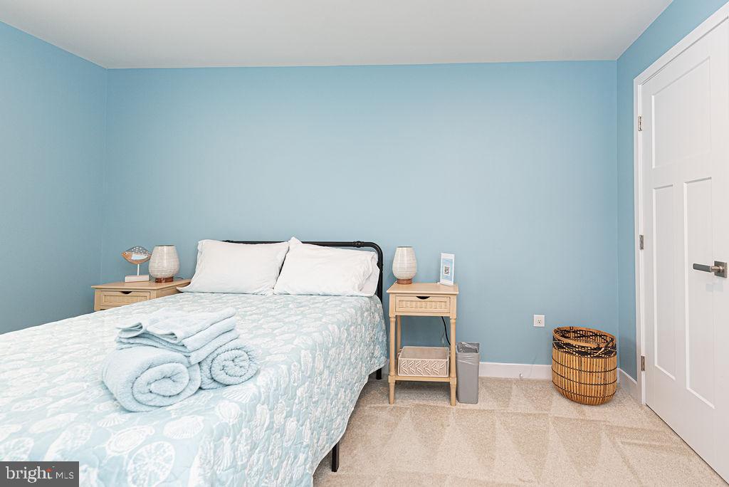 12461 Coastal Marsh Drive, Unit 708 Berlin, MD 21811 - Photo 43 of 56 a bedroom with bed and a table