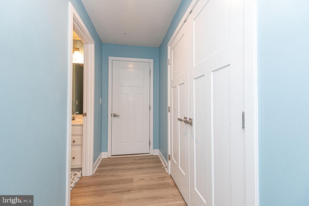 12461 Coastal Marsh Drive, Unit 708 Berlin, MD 21811 - Photo 44 of 56 a view of a hallway with wooden floor and entryway