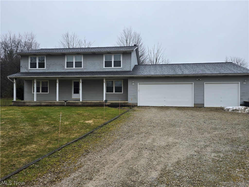 2672 Crackel Road Aurora, OH 44202 - Photo 1 of 38 View of front of home featuring driveway, covered porch, an attached garage, a shingled roof, and a front yard