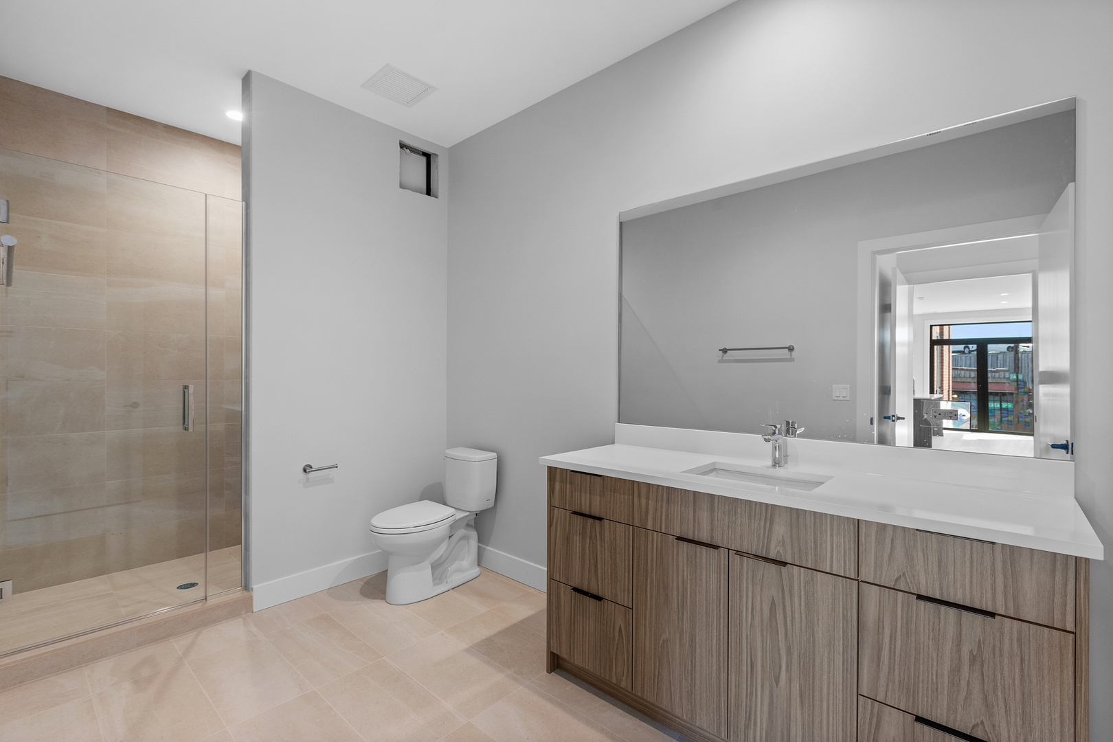 3953 West Dakin Street, Unit 405 Chicago, IL 60618 - Photo 15 of 21 a bathroom with a granite countertop sink a toilet and shower