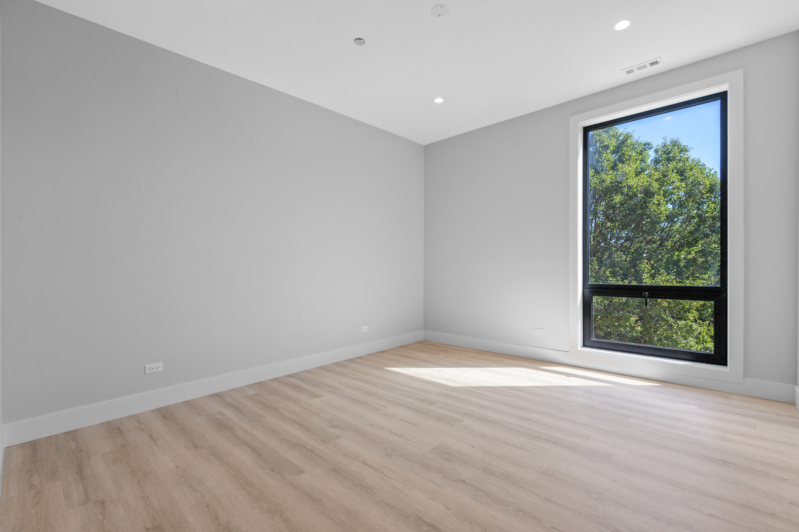 3953 West Dakin Street, Unit 405 Chicago, IL 60618 - Photo 18 of 21 an empty room with wooden floor and windows