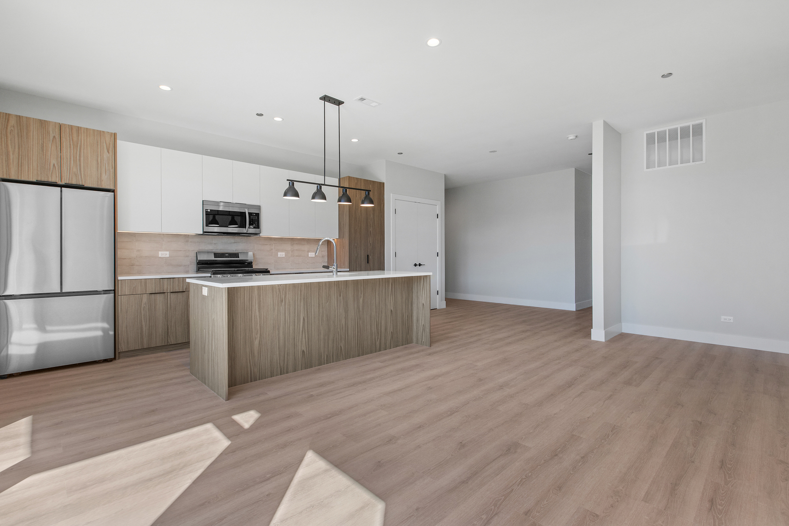 3953 West Dakin Street, Unit 405 Chicago, IL 60618 - Photo 5 of 21 a kitchen with stainless steel appliances a refrigerator sink and microwave