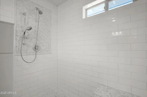 a bathroom with a glass shower door
