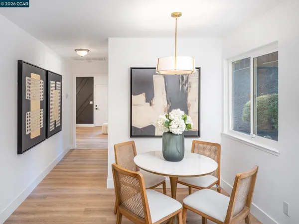 a living room with furniture a flat screen tv and a chandelier