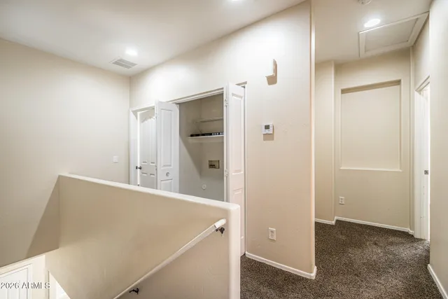 a view of a hallway with cabinets