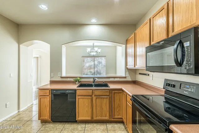 a kitchen with stainless steel appliances granite countertop a sink and a stove